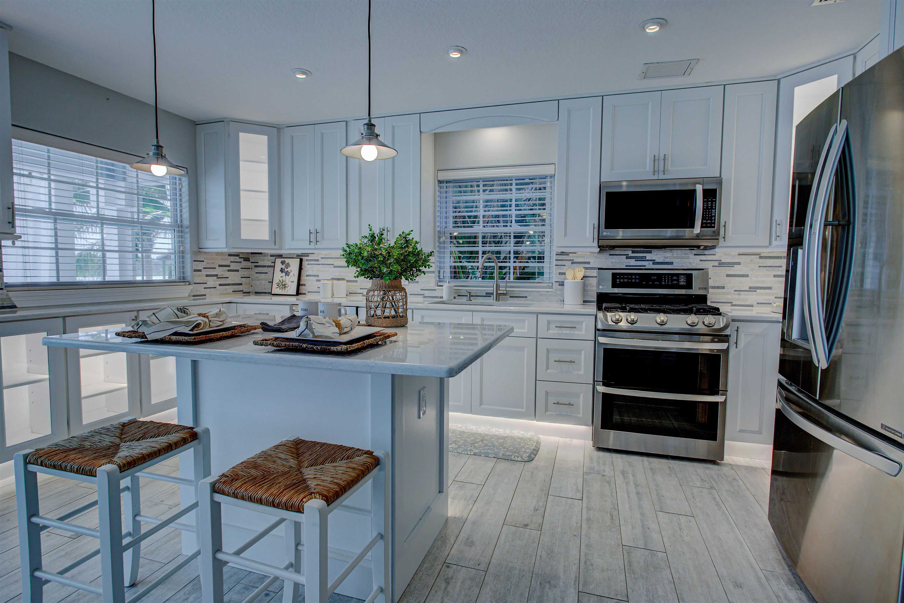 9151 June Lane St. Augustine, FL 32080 - Photo 42 of 73 a kitchen with granite countertop a stove a sink and a refrigerator