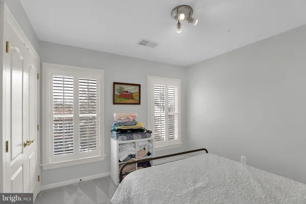 a view of a bedroom with a bed and a window