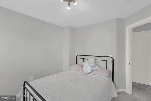 a bedroom with a bed and chandelier