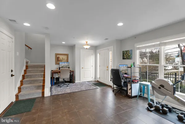 a view of a livingroom with workspace and a window