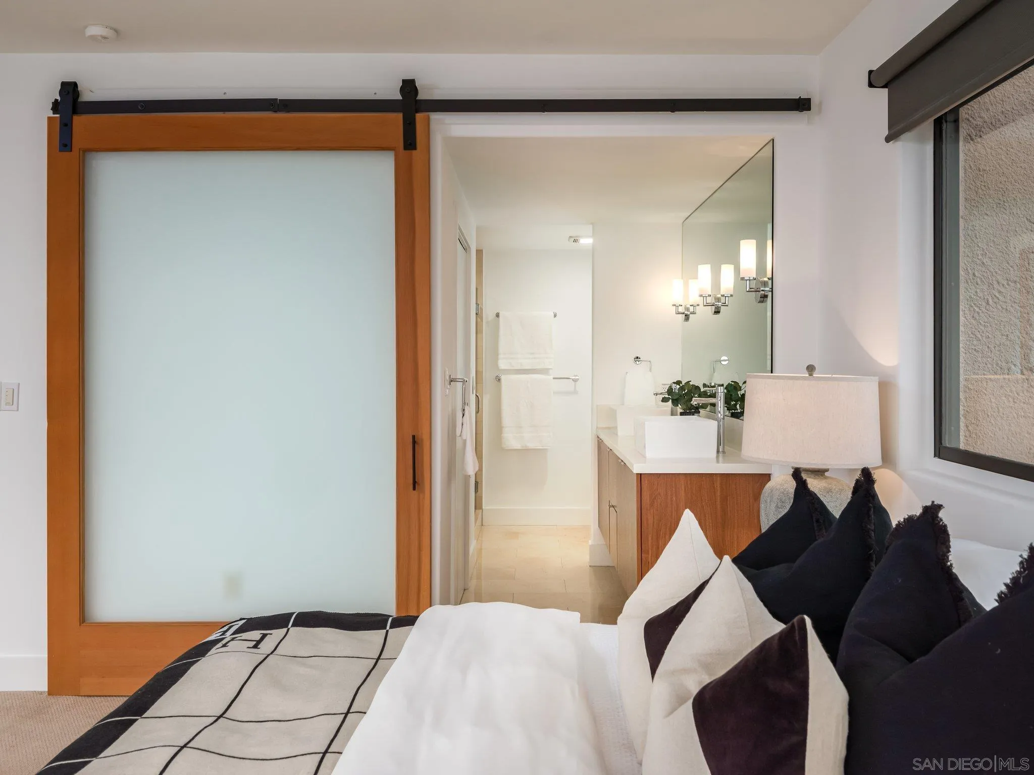 2500 Torrey Pines Road, Unit 1001 La Jolla, CA 92037 - Photo 17 of 30 a bedroom with a bed and a mirror