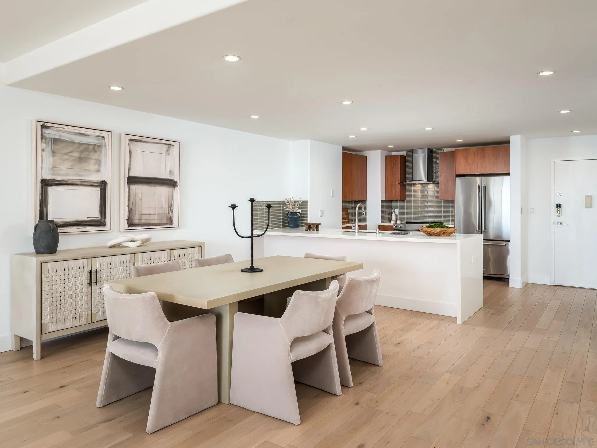 2500 Torrey Pines Road, Unit 1001 La Jolla, CA 92037 - Photo 8 of 30 a kitchen with white cabinets and chairs