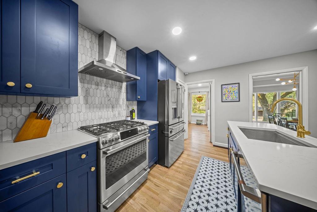 11714 El Hara Circle Dallas, TX 75230 - Photo 11 of 40 a kitchen with granite countertop a stove and a sink
