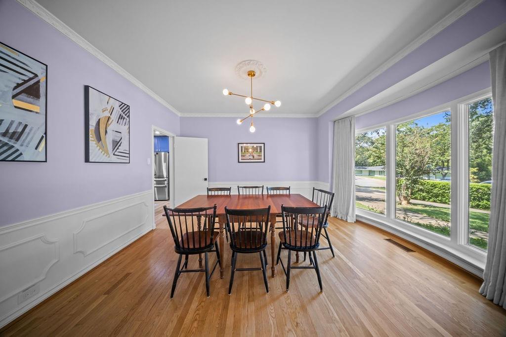 11714 El Hara Circle Dallas, TX 75230 - Photo 16 of 40 a view of a dining room with furniture wooden floor and chandelier