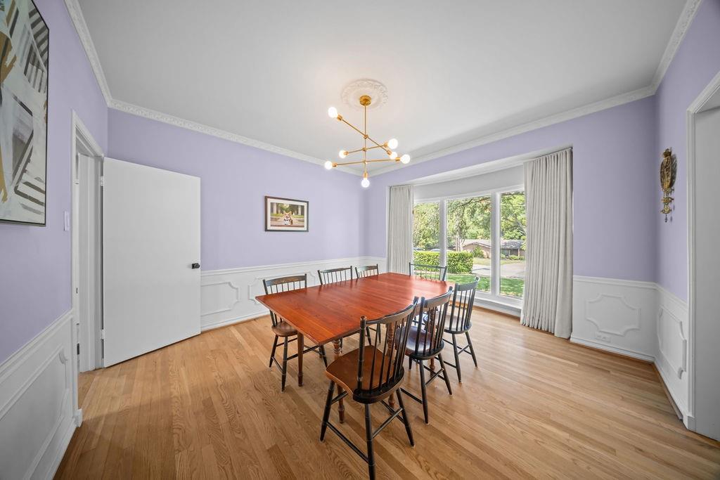 11714 El Hara Circle Dallas, TX 75230 - Photo 17 of 40 a dining room with furniture a chandelier and wooden floor