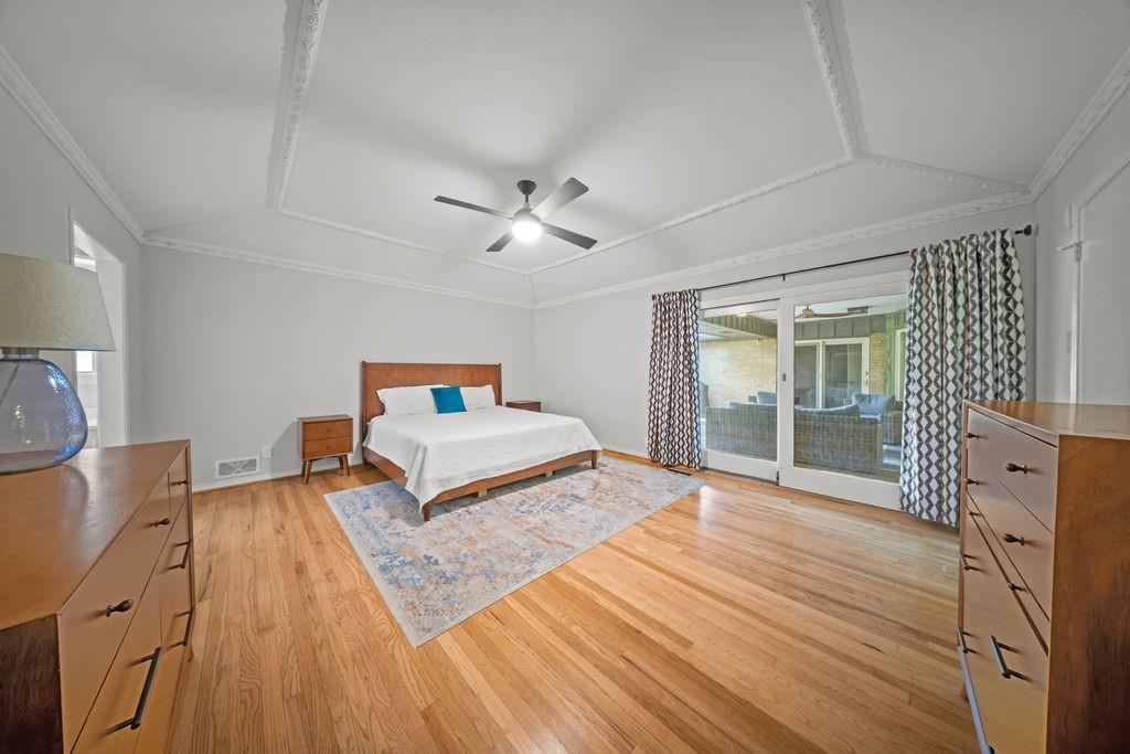 11714 El Hara Circle Dallas, TX 75230 - Photo 18 of 40 a bedroom with a bed and a chandelier