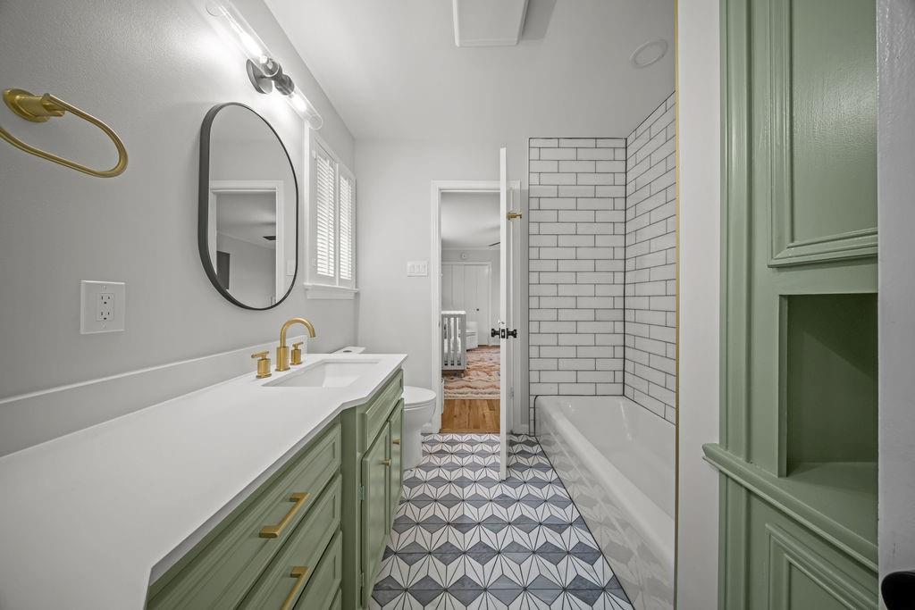 11714 El Hara Circle Dallas, TX 75230 - Photo 25 of 40 a bathroom with a sink a toilet and shower