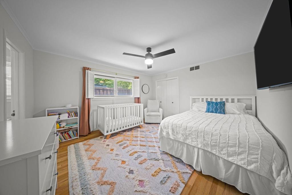 11714 El Hara Circle Dallas, TX 75230 - Photo 26 of 40 a bedroom with a bed a flat screen tv and a window