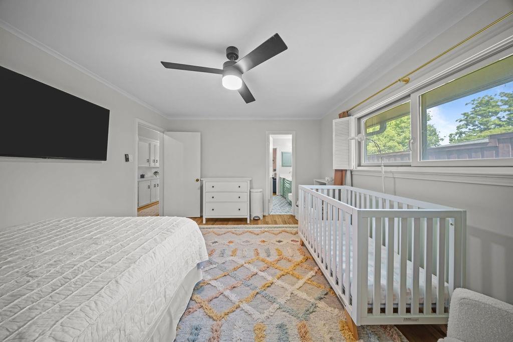 11714 El Hara Circle Dallas, TX 75230 - Photo 27 of 40 a spacious bedroom with a bed and a flat screen tv