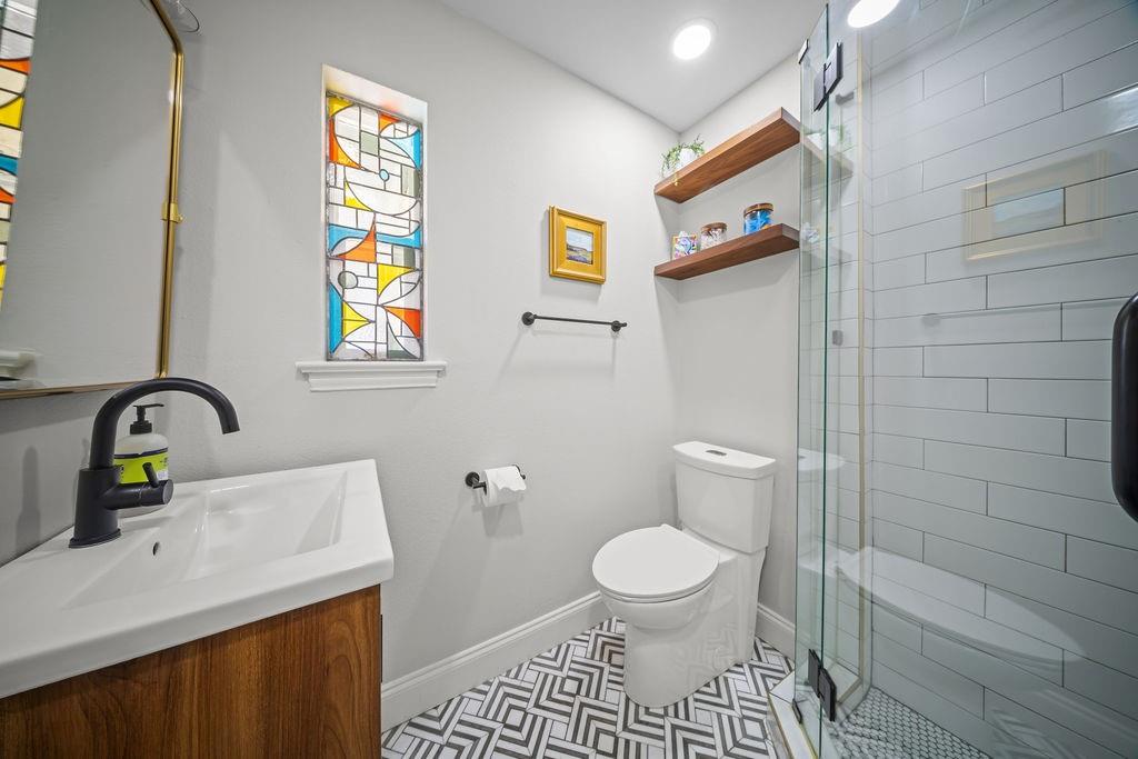 11714 El Hara Circle Dallas, TX 75230 - Photo 30 of 40 a bathroom with a sink a toilet and shower