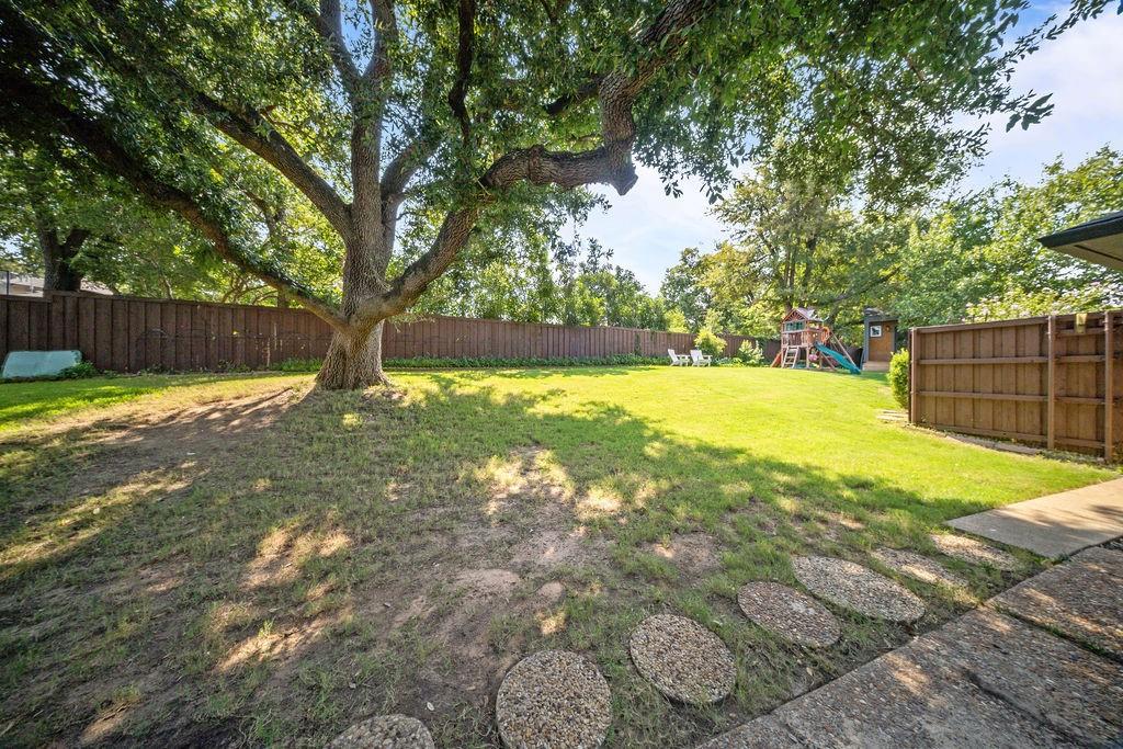 11714 El Hara Circle Dallas, TX 75230 - Photo 32 of 40 a view of yard with large trees and wooden fence