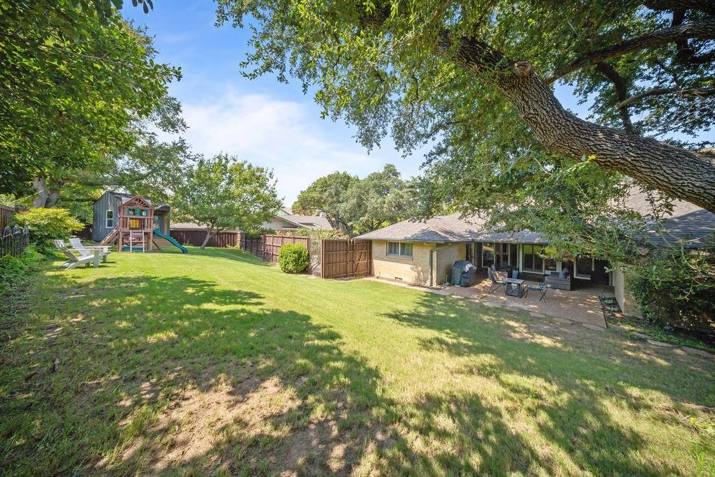 11714 El Hara Circle Dallas, TX 75230 - Photo 33 of 40 a front view of a house with a yard