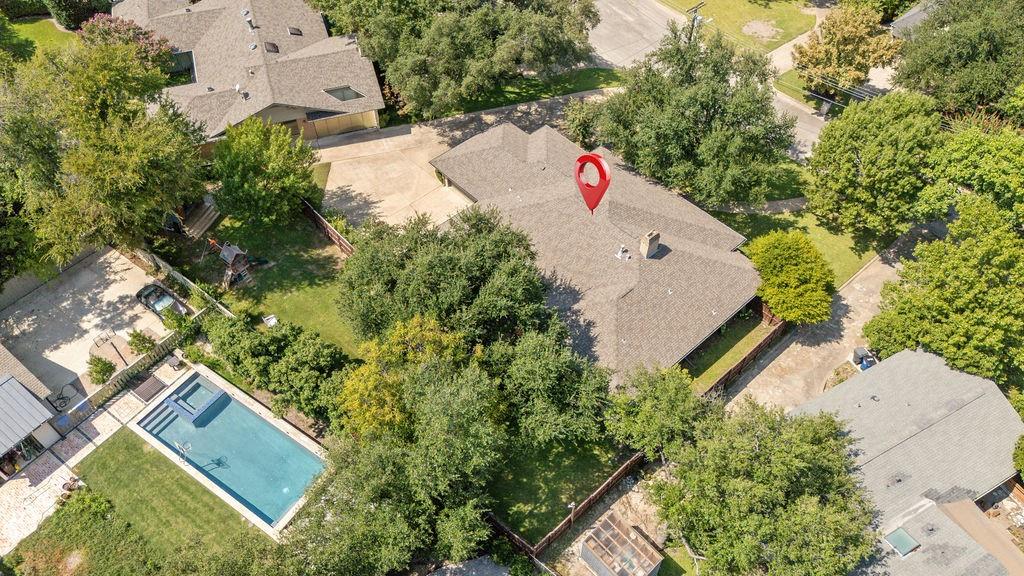 11714 El Hara Circle Dallas, TX 75230 - Photo 39 of 40 an aerial view of a house with a yard and trees