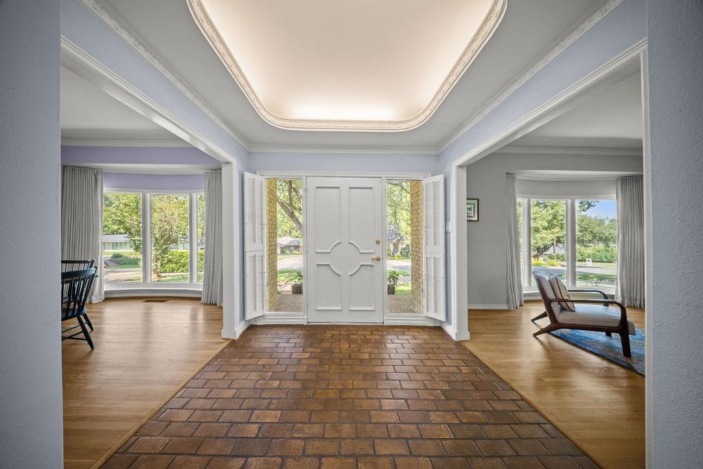 11714 El Hara Circle Dallas, TX 75230 - Photo 5 of 40 a view of an entryway with wooden floor and garden