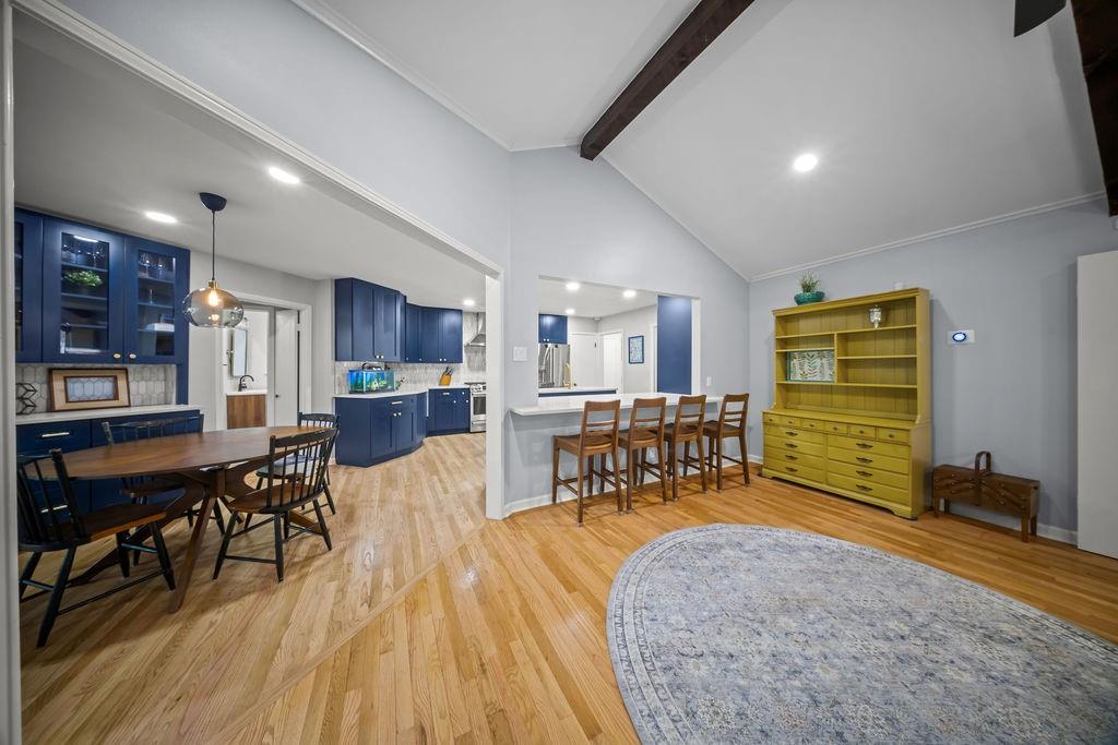 11714 El Hara Circle Dallas, TX 75230 - Photo 9 of 40 a living room with furniture and a dining table with wooden floor