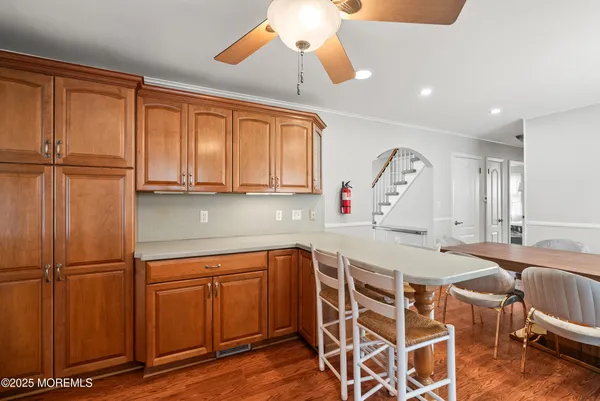 a view of a kitchen with dining area a sink and wooden floor