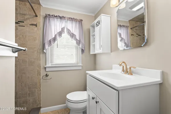 a bathroom with a sink a mirror and a toilet