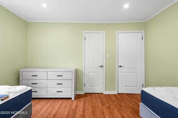 a bedroom with a bed and a dresser