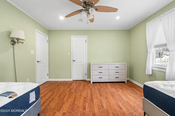 a room with a dresser and a chandelier