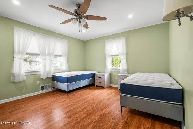 a bedroom with a bed and windows