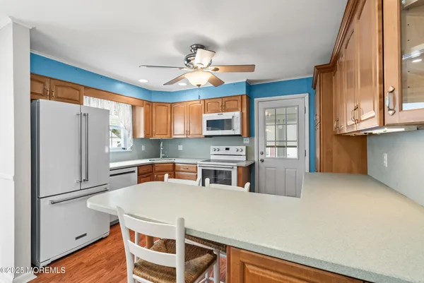 a kitchen with stainless steel appliances a stove a refrigerator and cabinets