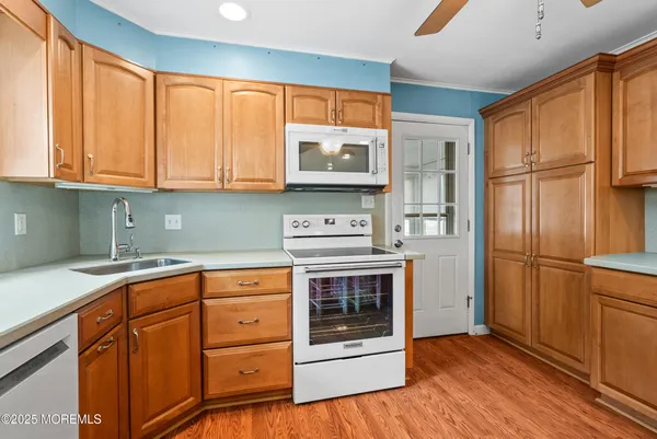 a kitchen with stainless steel appliances granite countertop a refrigerator sink and cabinets