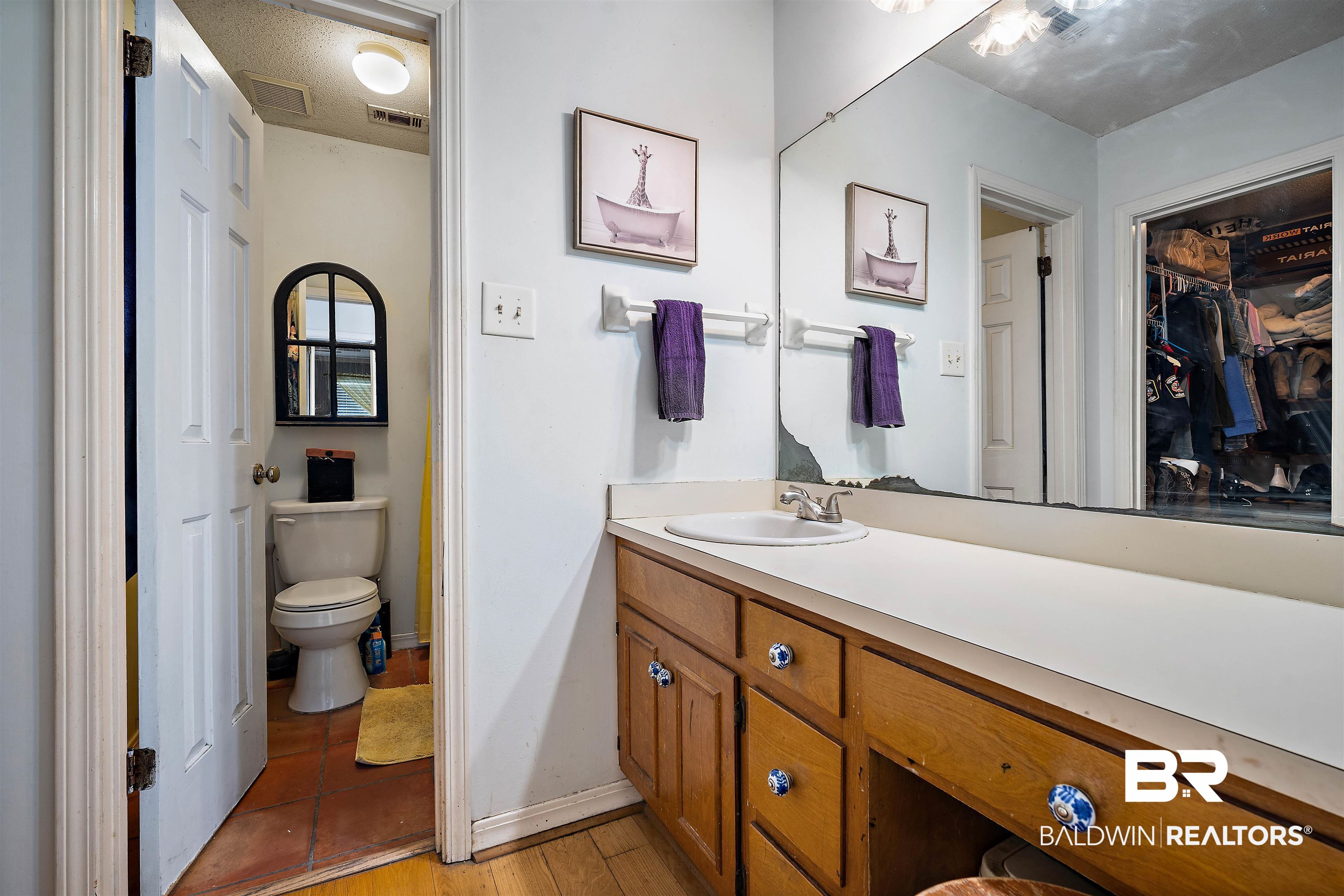 2823 Woodland Road Mobile, AL 36693 - Photo 13 of 29 Bathroom featuring wood finished floors, vanity, baseboards, toilet, and visible vents