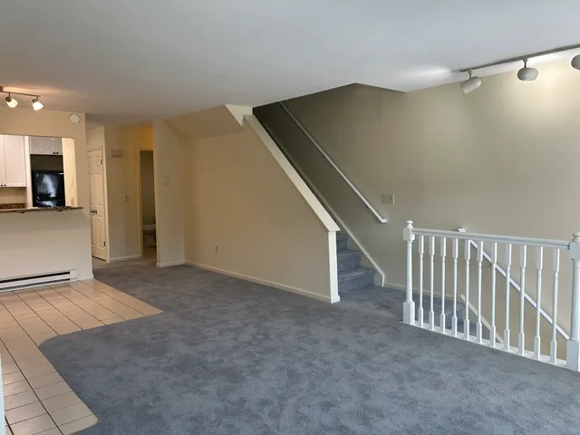a view of an empty room with stairs