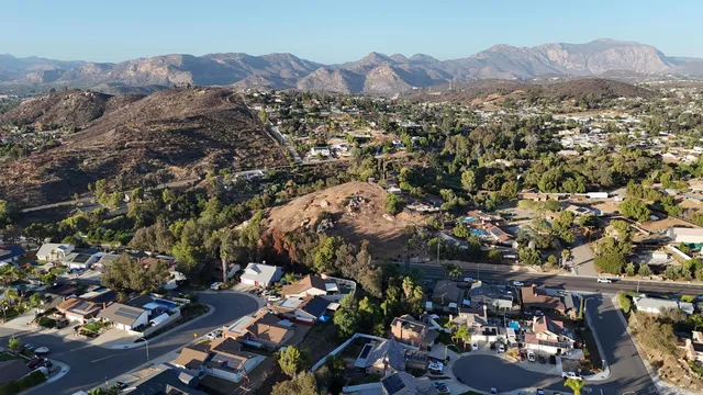 an aerial view of residential house with parking and mountain view