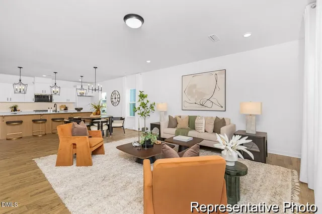 a living room with lots of furniture and kitchen view