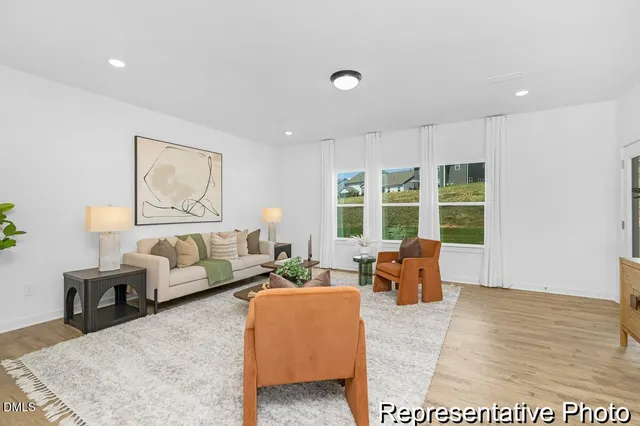 a living room with furniture and large window