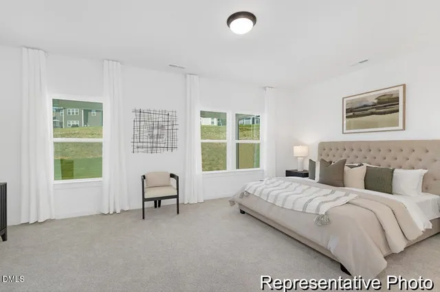 a bedroom with a bed and a chair