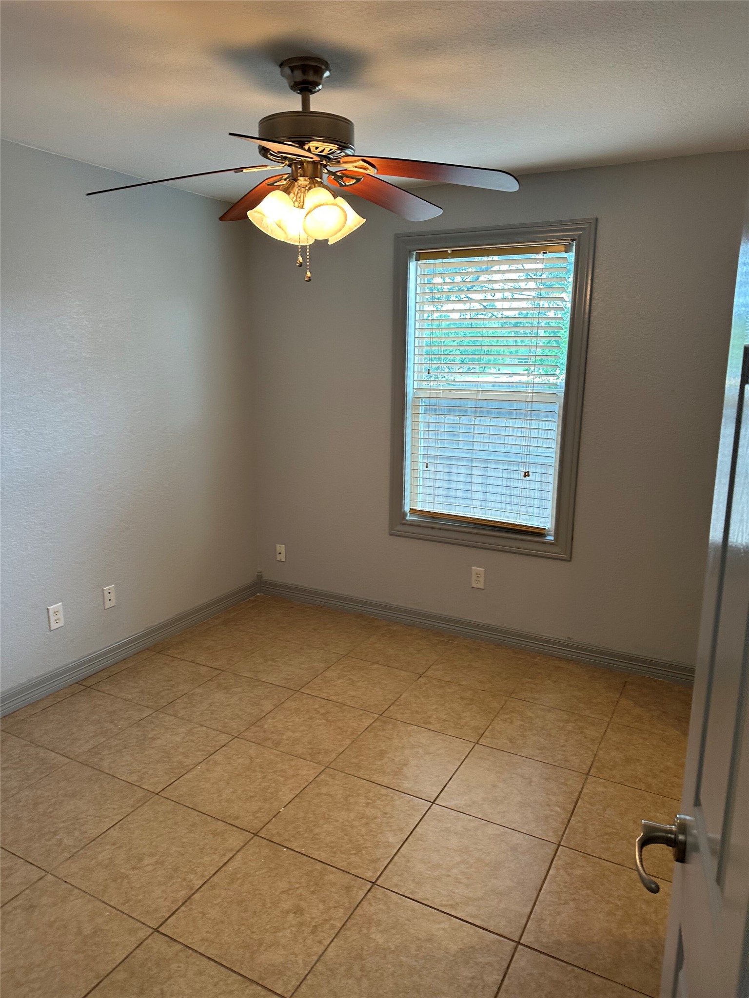 2743 Maple Tree Road, Unit A New Braunfels, TX 78130 - Photo 13 of 18 Empty room with a ceiling fan and light tile patterned floors