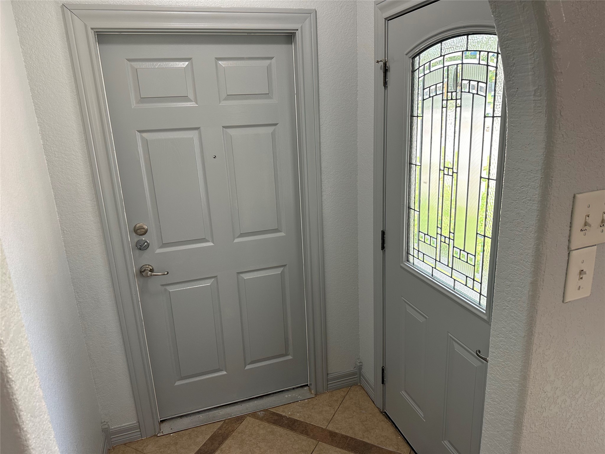 2743 Maple Tree Road, Unit A New Braunfels, TX 78130 - Photo 2 of 18 Foyer entrance featuring a textured wall and light tile patterned flooring