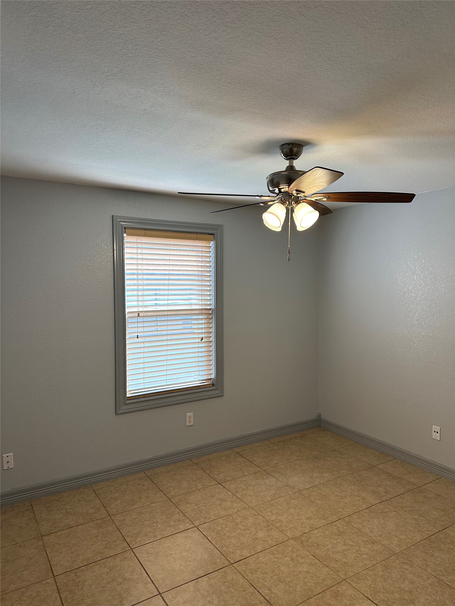 2743 Maple Tree Road, Unit A New Braunfels, TX 78130 - Photo 6 of 18 Unfurnished room featuring a ceiling fan and a textured ceiling