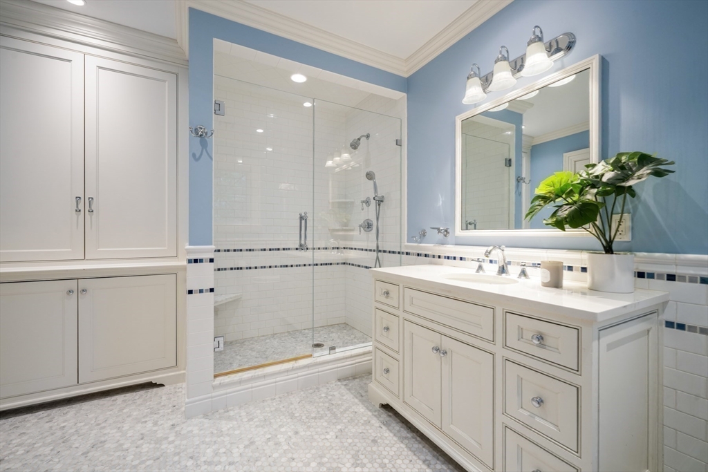 121 Livingston Road Wellesley, MA 02482 - Photo 23 of 42 a bathroom with a double vanity sink mirror and shower
