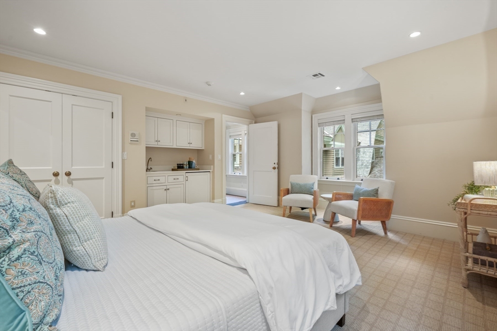 121 Livingston Road Wellesley, MA 02482 - Photo 24 of 42 a spacious bedroom with a bed and a chair