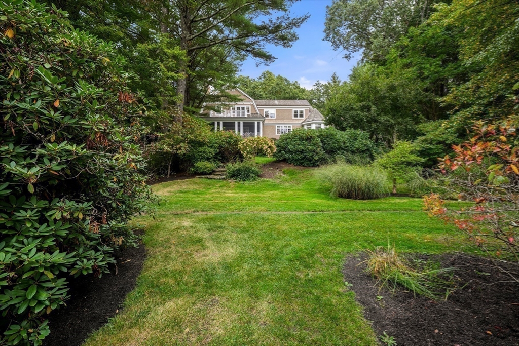 121 Livingston Road Wellesley, MA 02482 - Photo 38 of 42 a view of a garden with a building in the background