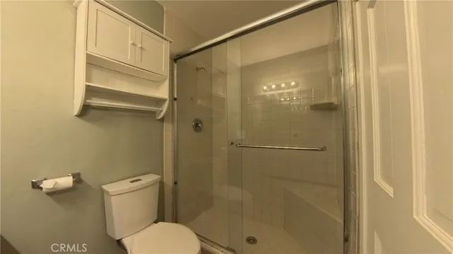 a bathroom with a shower and a toilet