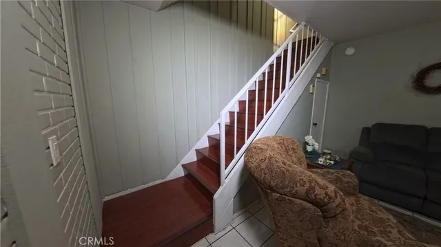 a living room with furniture and stairs