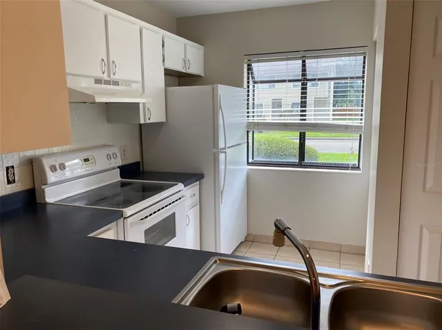 a kitchen with a refrigerator and a sink