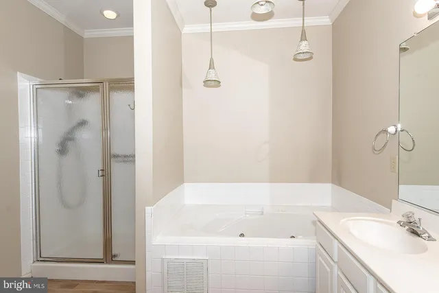 a bathroom with a tub sink and shower