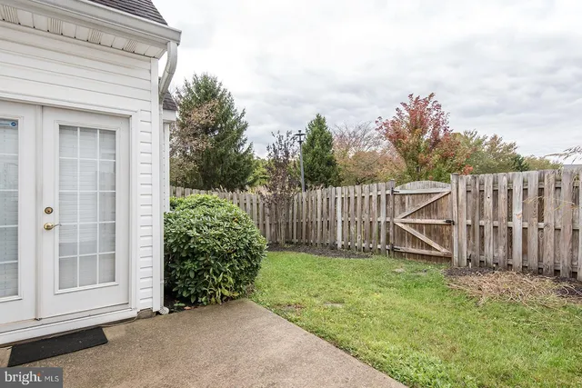 a view of a backyard with wooden fence