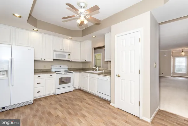 a kitchen with a white cabinets and white appliances