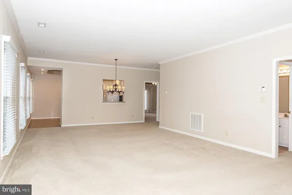 an empty room with entrance and windows