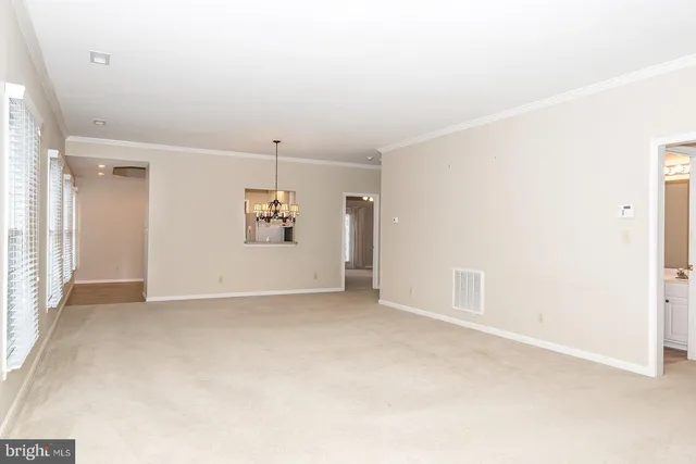 an empty room with entrance and windows