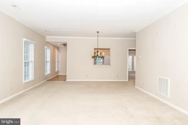 a view of a livingroom with a ceiling fan and window