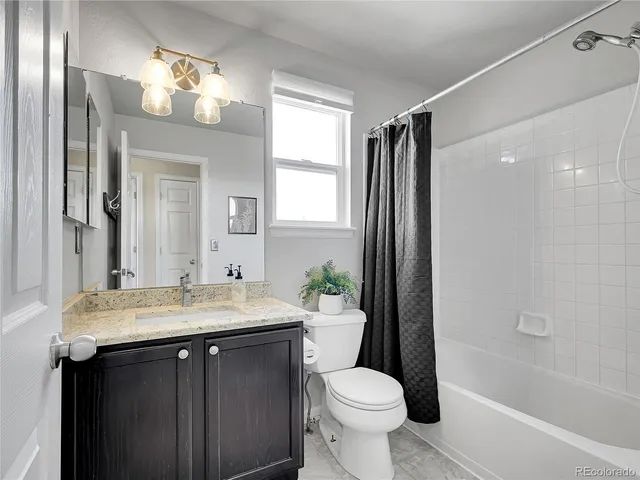 a bathroom with a sink toilet a mirror and shower