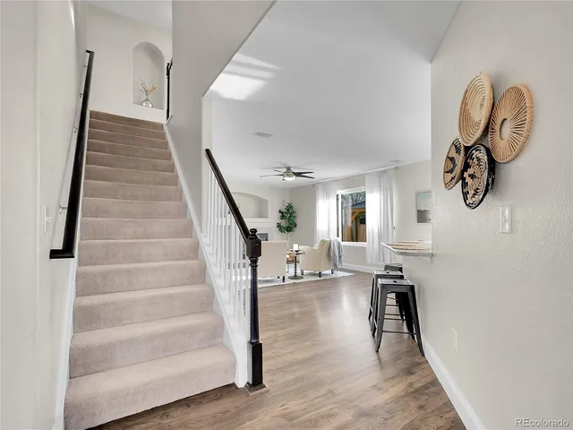 a view of entryway and hall with wooden floor
