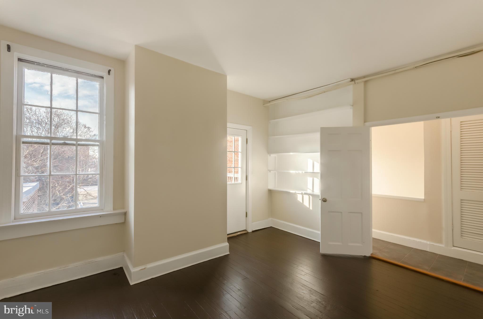 10 7th Street Northeast Washington, DC 20002 - Photo 19 of 30 a view of an empty room with a window and wooden floor